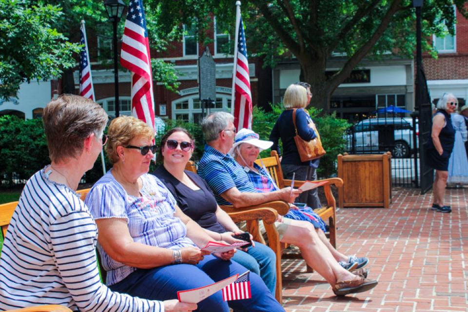 Community members wait for program to start.