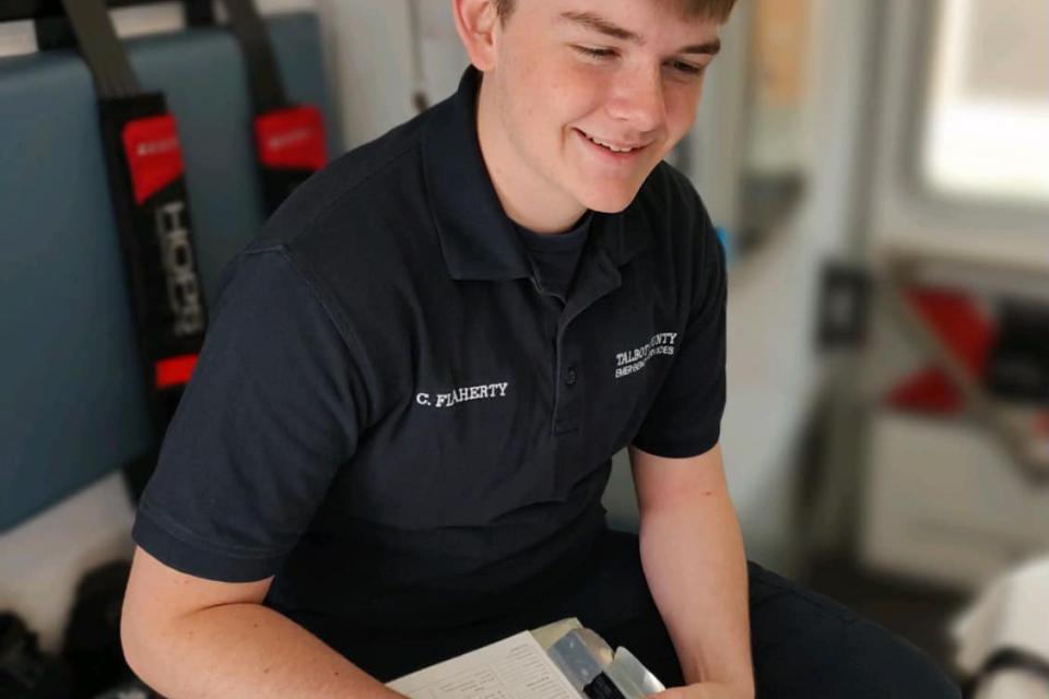 Connor Flaherty, participant in the apprenticeship program, fills out patient details.