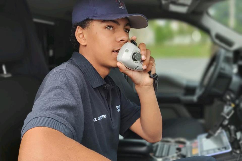 Geo Greaves, participant in the apprenticeship program, provides details to dispatch during a call.