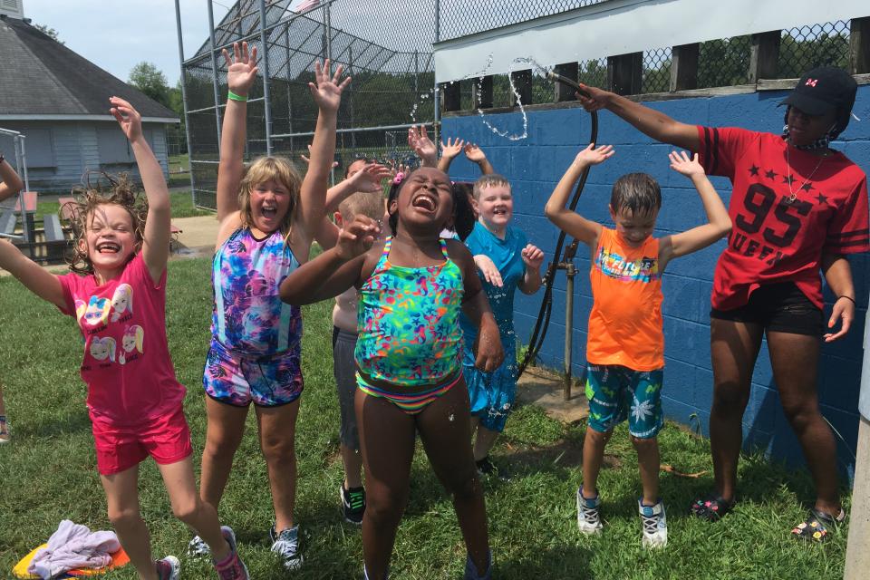Campers enjoying splish and splash in summer heat.