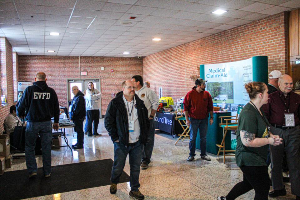 Participants talk to exhibitors in between sessions.