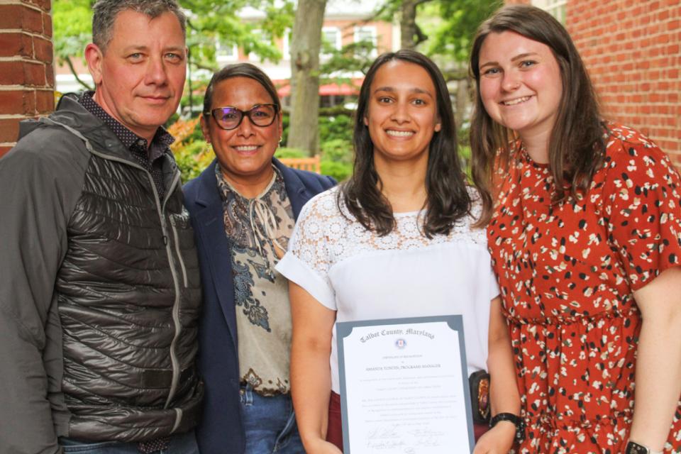 Amanda Tondin celebrates "Employee of the Year" recognition with family members