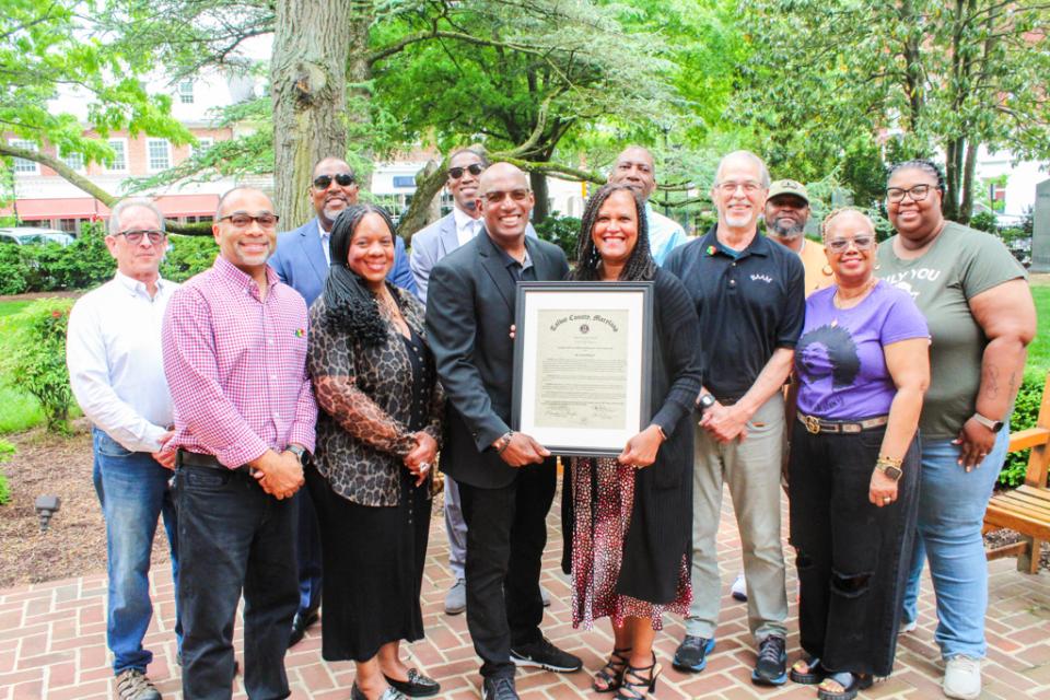 BAAM Co-Founders Derick and Dina Daly stand with staff and board members.