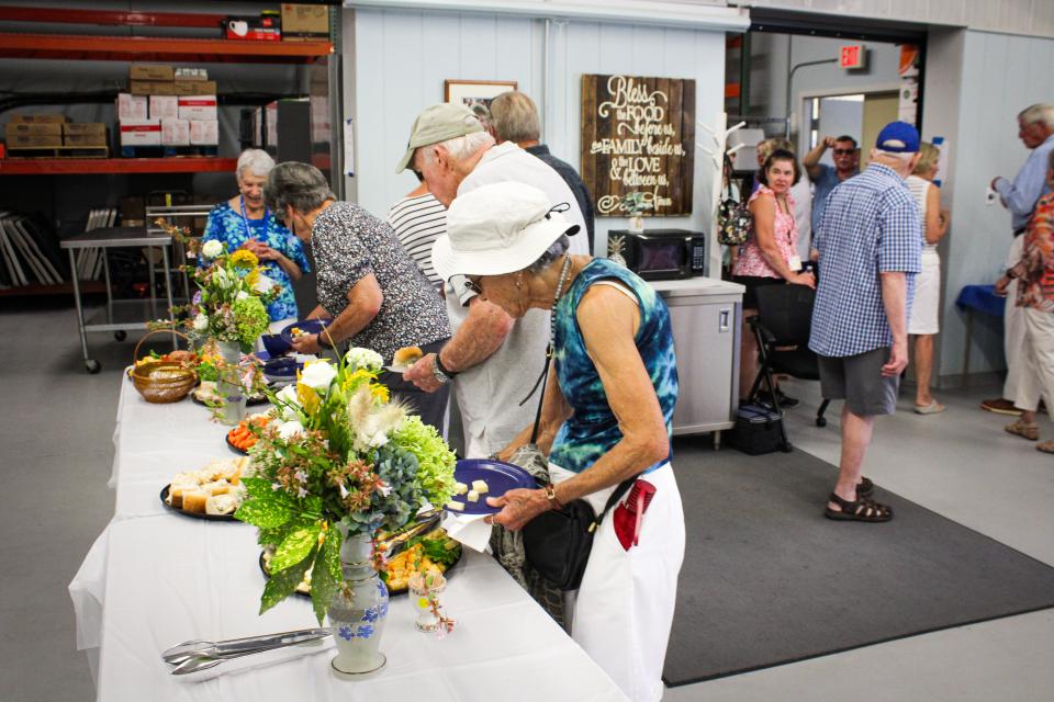 Attendees were treated to air conditioning and a lunch spread while looking at the architectural drawings and seeing the food pantry.