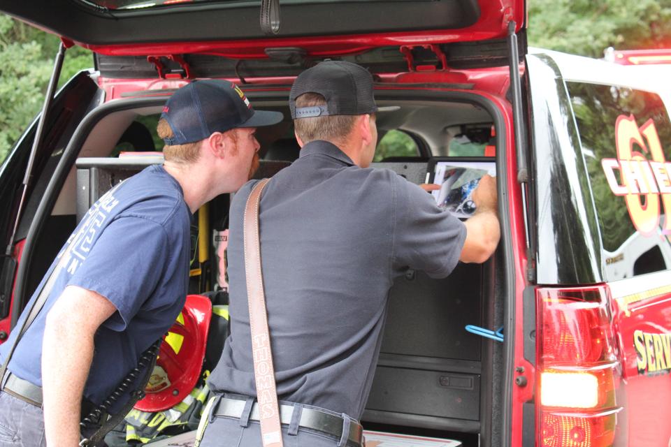 Members of the Anne Arundel County hazardous materials team review images supplied by the drone prior to entering the scene.