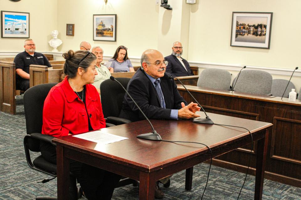Megan Greenwood, left, and Dr. Fahmi, right,. discuss the Health Department's recent collaboration with Global Vision and local ophthalmologists and optometrists.