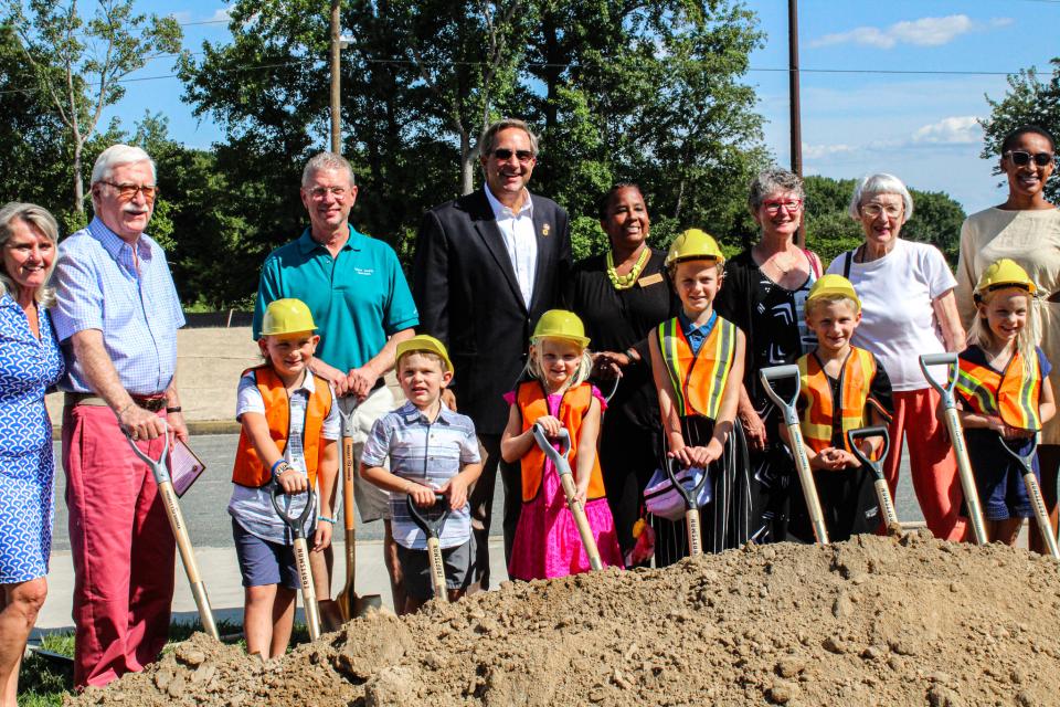 Critchlow Adkins board members and students shovel dirt during the groundbreaking.