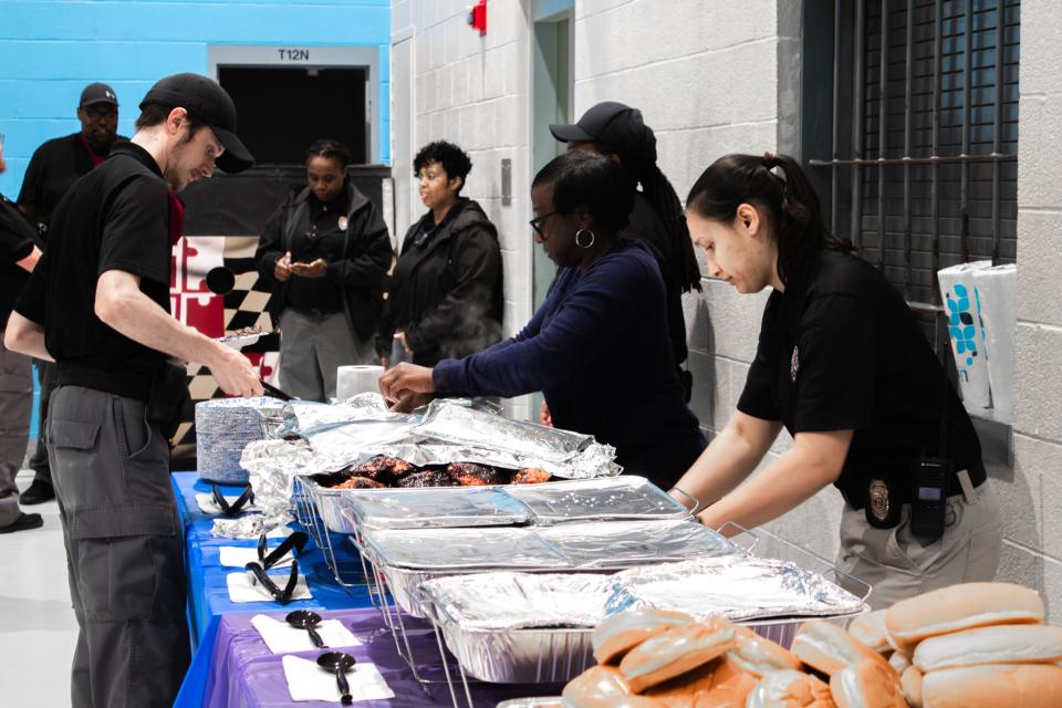 Deputy Green and Captain Tondin serve food during the Correctional Officer's Week luncheon.